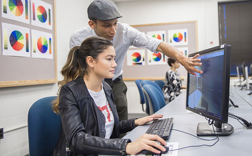 student at computer with instructor