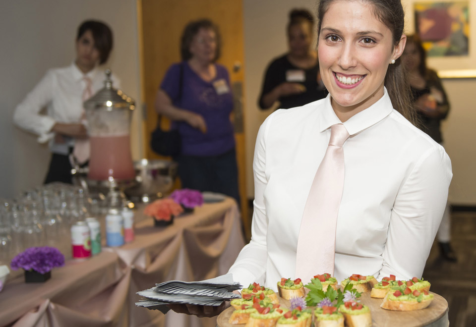 Hospitality student holding serving tray