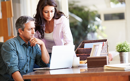 couple concentrating at their laptop
